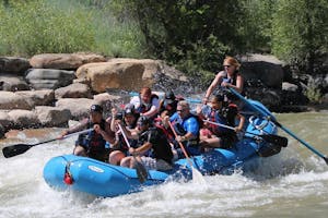 group of rafters going down a rapid