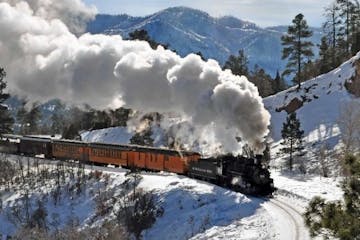 historic train riding through mountains