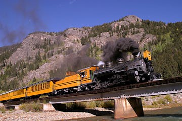 historic train riding along rocky mountains