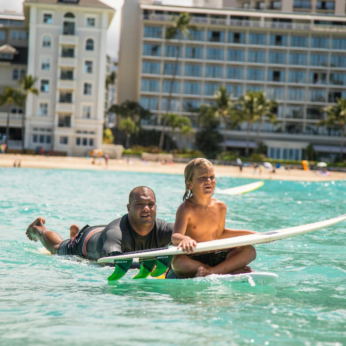 boy getting surf lesson honolulu