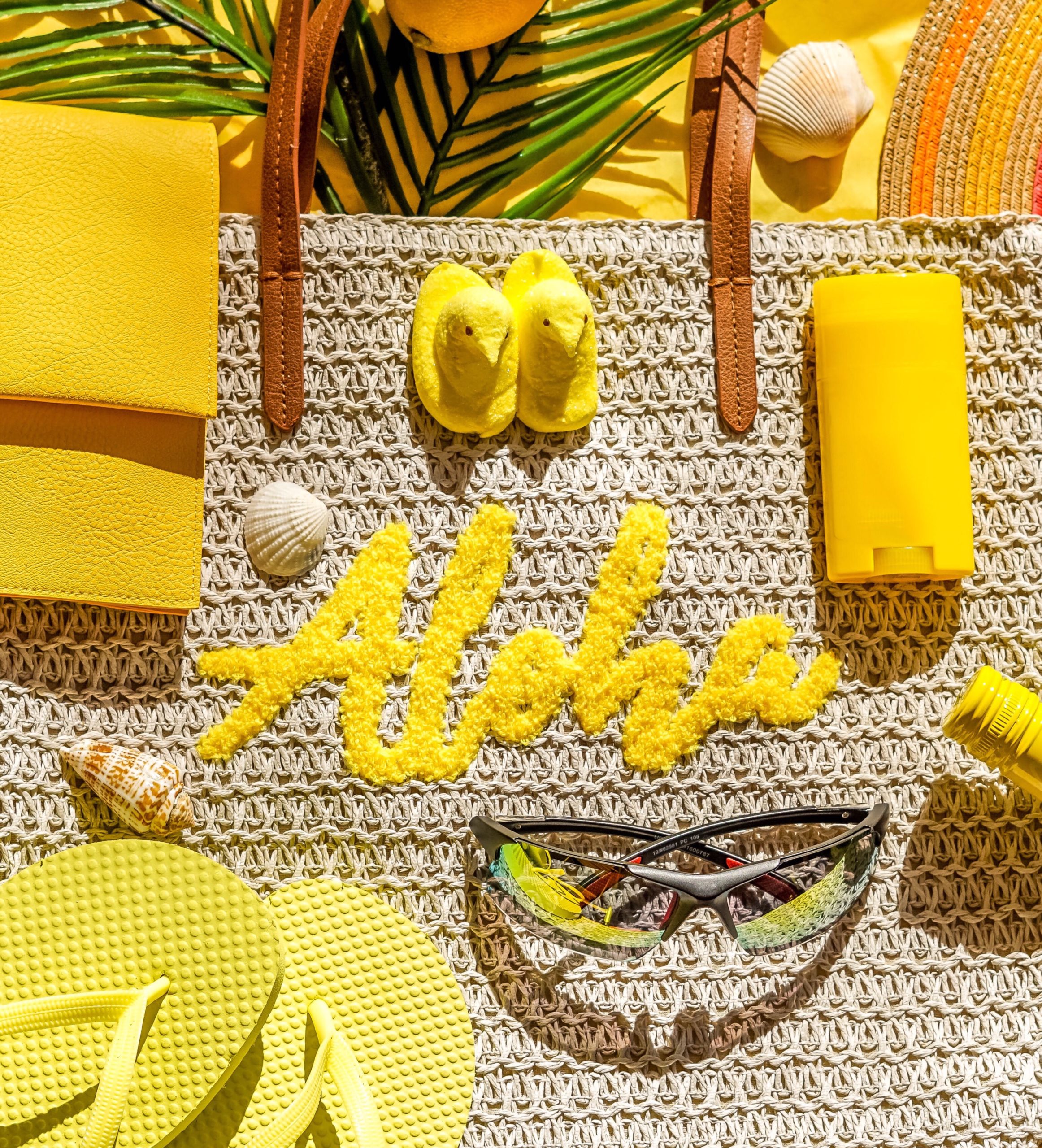 yellow-flatlay-of-beach-items-like-aloha-tote-suns-WBM6HUDAQ