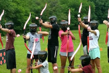 a group of girls playing arrow tag