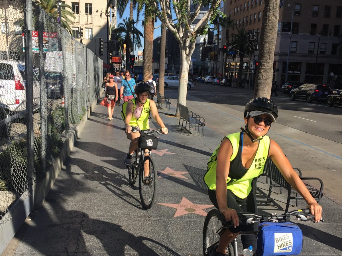 a group of people biking down the hollywood walk of fame