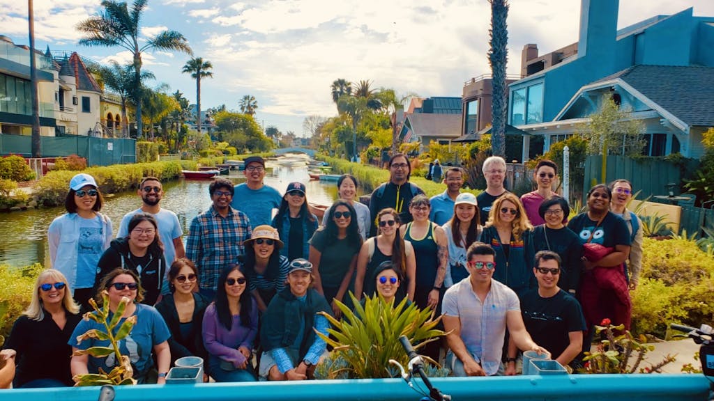 a group of people posing for a photo on a tour of the venice canals los angeles