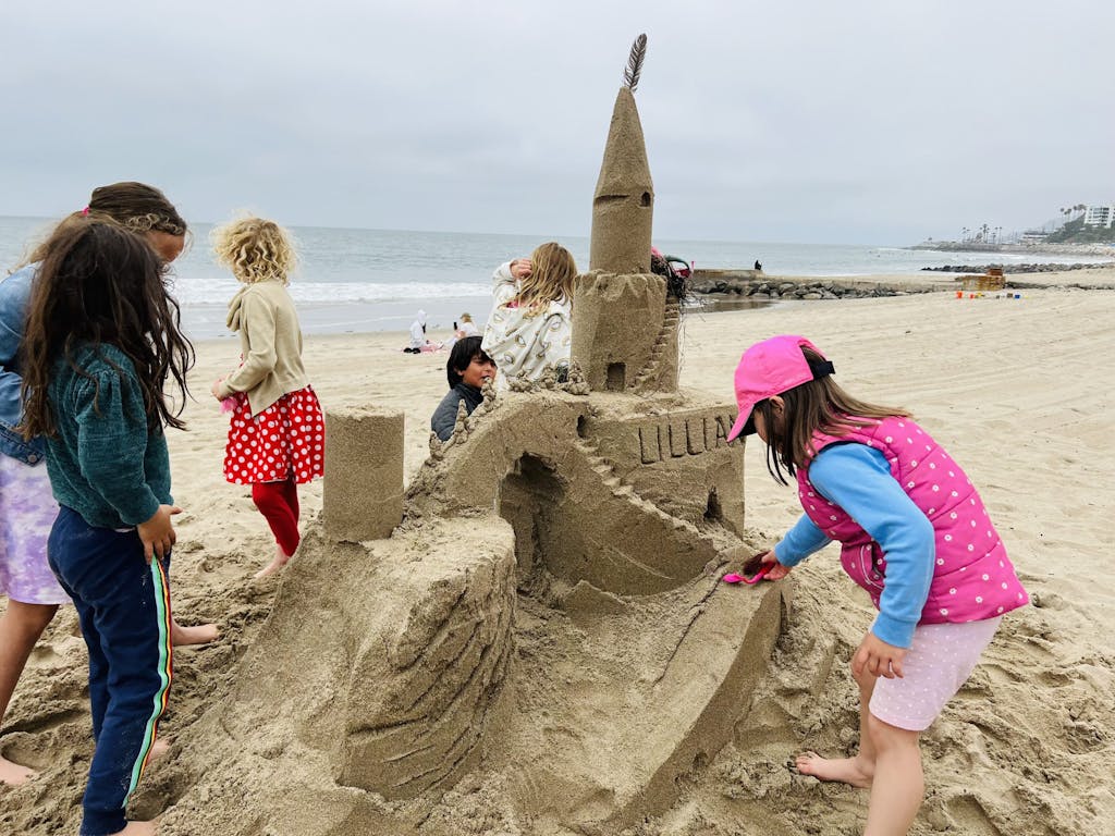 a group of people build a sand castle with bikes and hikes la