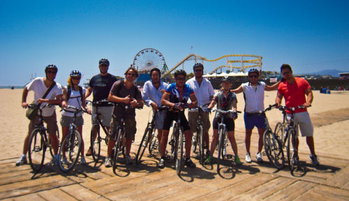 A group of people on bikes on the beach in Los Angeles