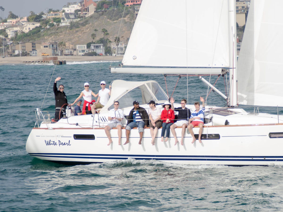 A group of people with their feet hanging off the side of the boat in Los Angeles