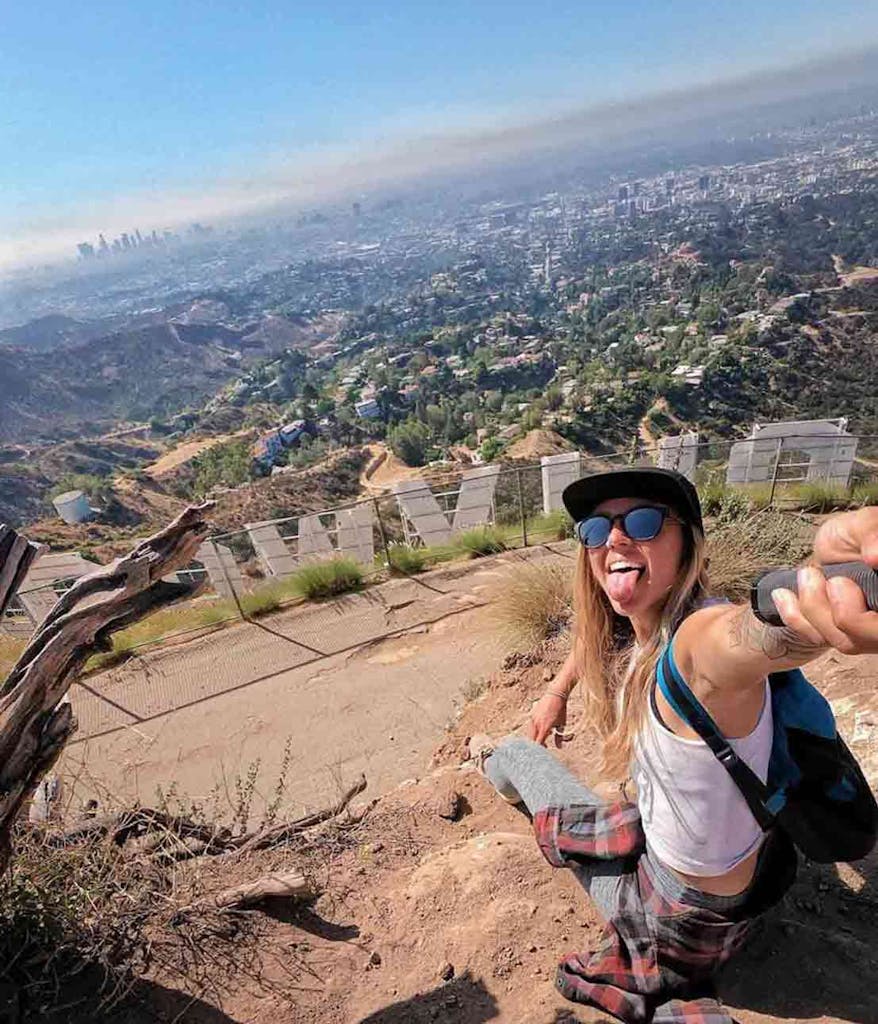 Girl behind Hollywood Sign on hike