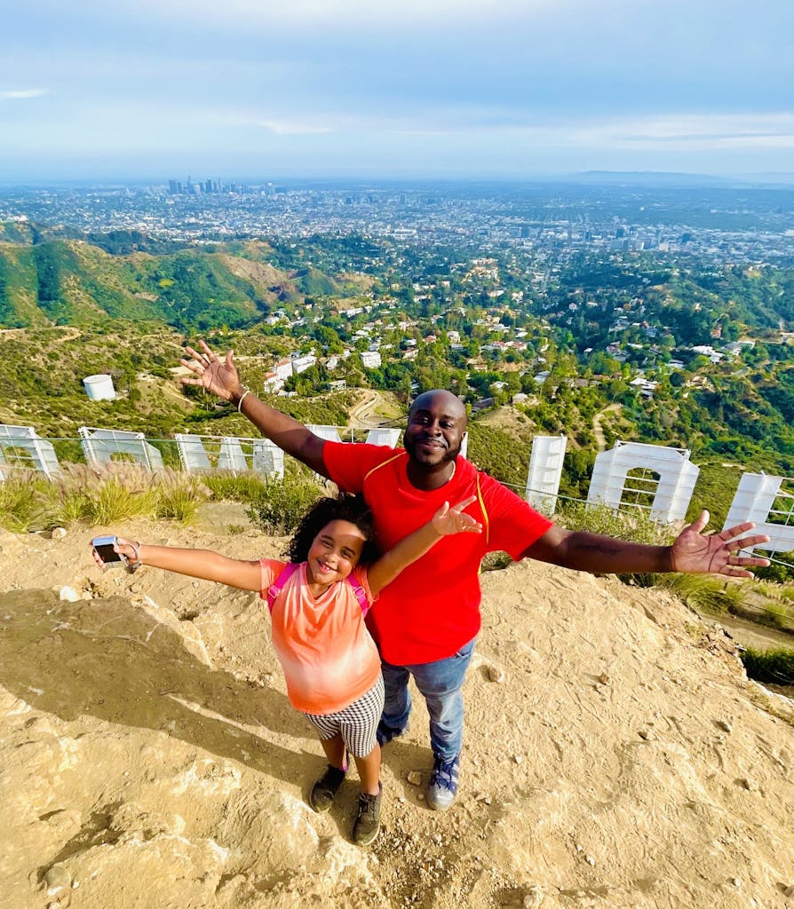 two guests behind the hollywood sign on our hollywood sign los angeles tour