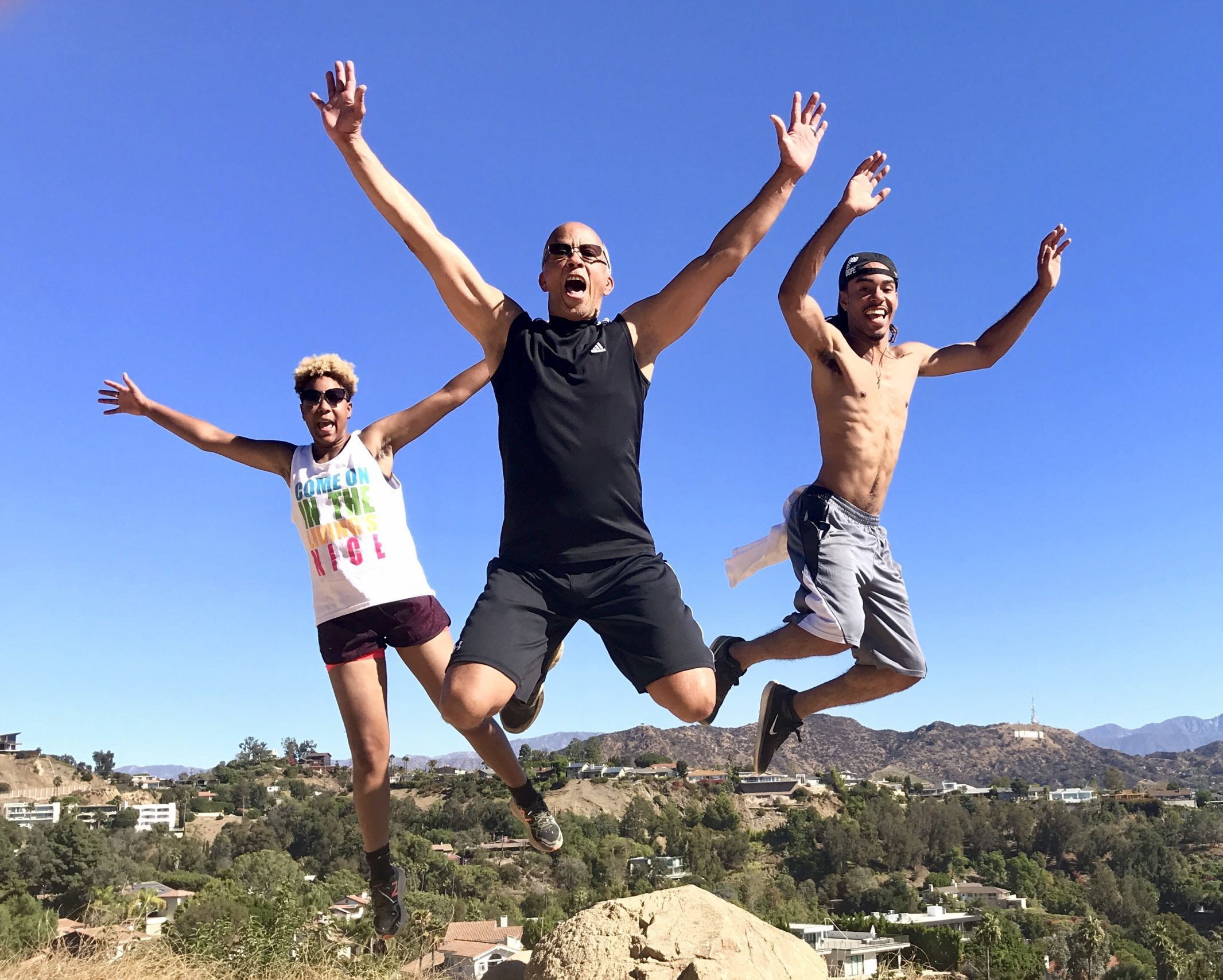 a group of people jumping in the air on a hollywood hills hike