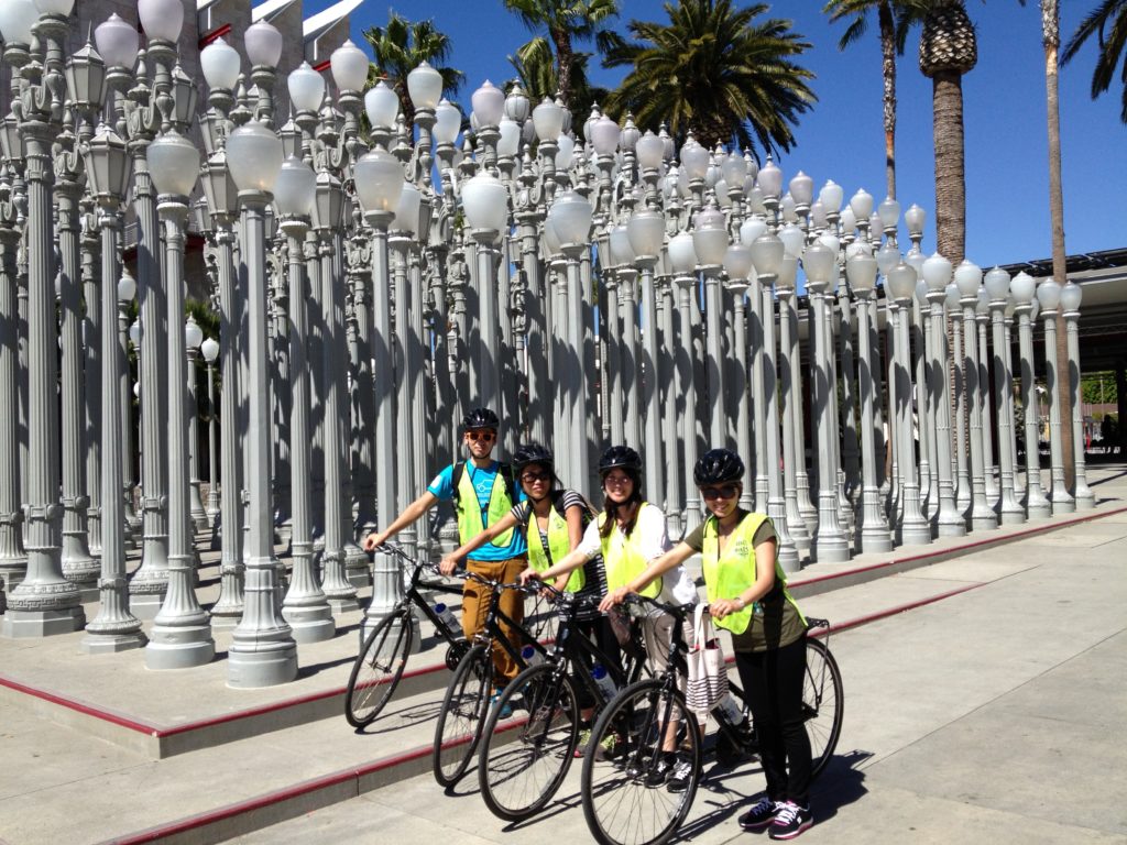 A group of people on a bike tour in front of the LA County Art Museum