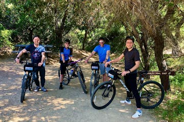 a group of people riding on the back of a bicycle on a group tour of westlake