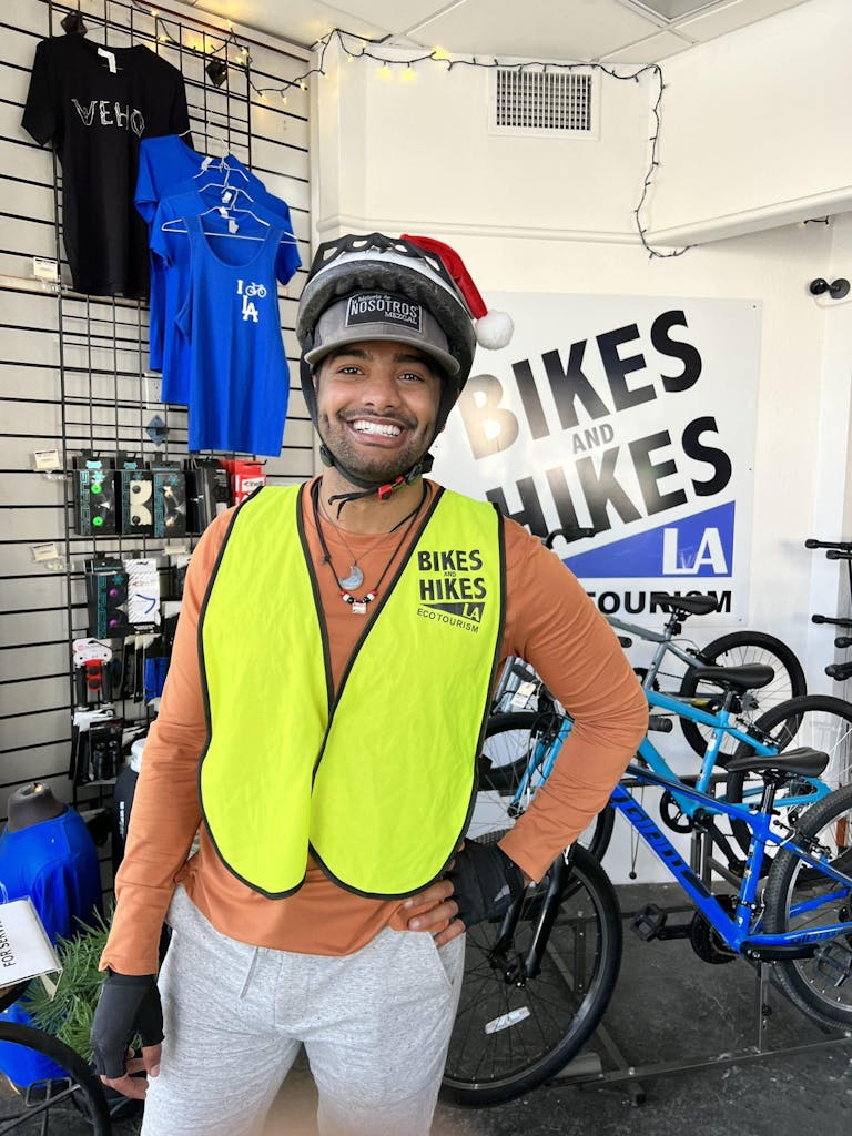 a person wearing a blue hat holding a bicycle