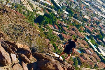 a guest climbing a mountain on a palm springs hike