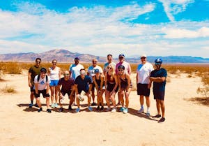 a group of people standing in the desert on a joshua tree group tour