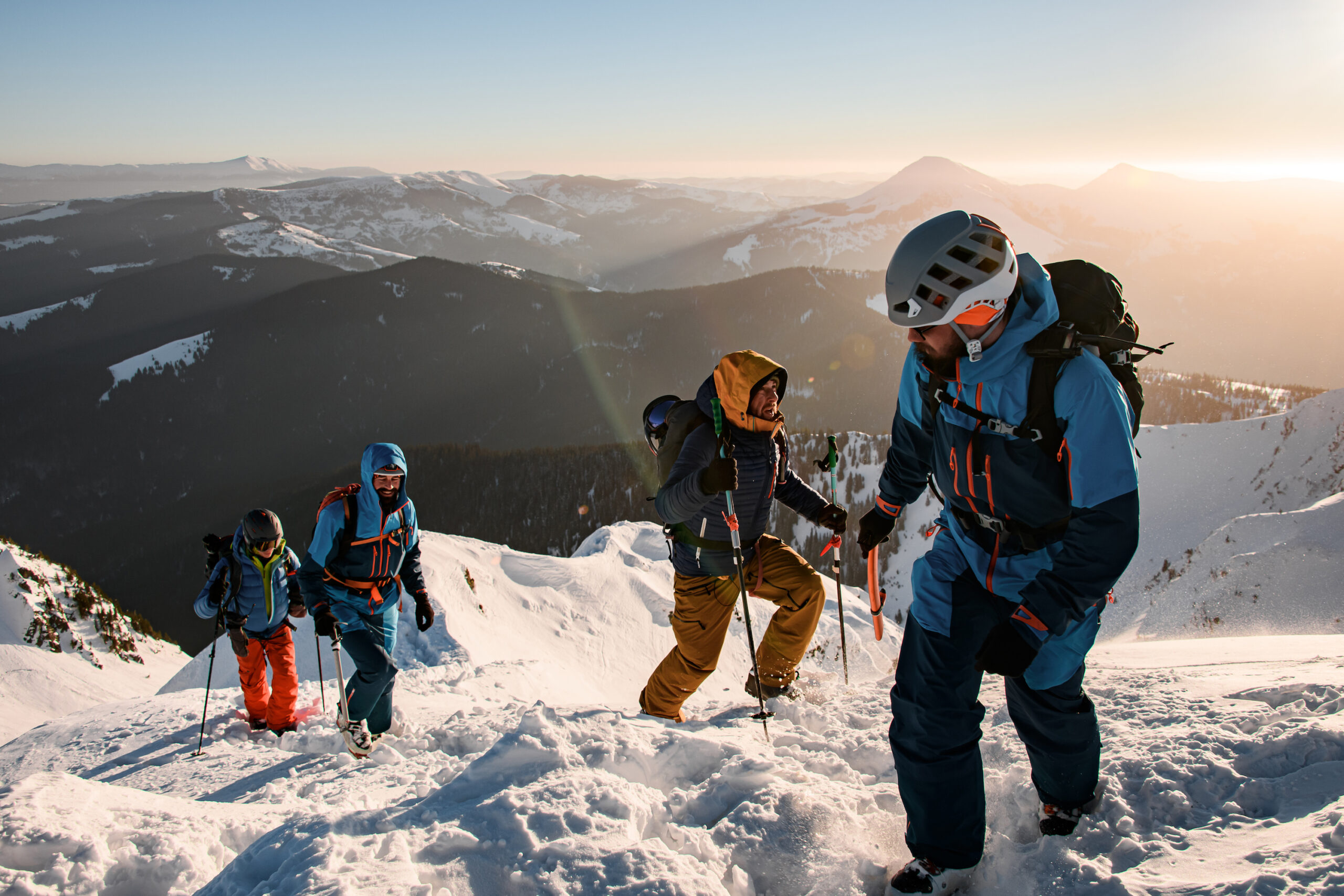 a group of people standing on top of a snow covered mountain