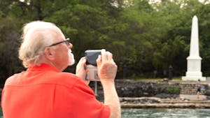 Tourist taking a photo of historic landmarks from the cruise