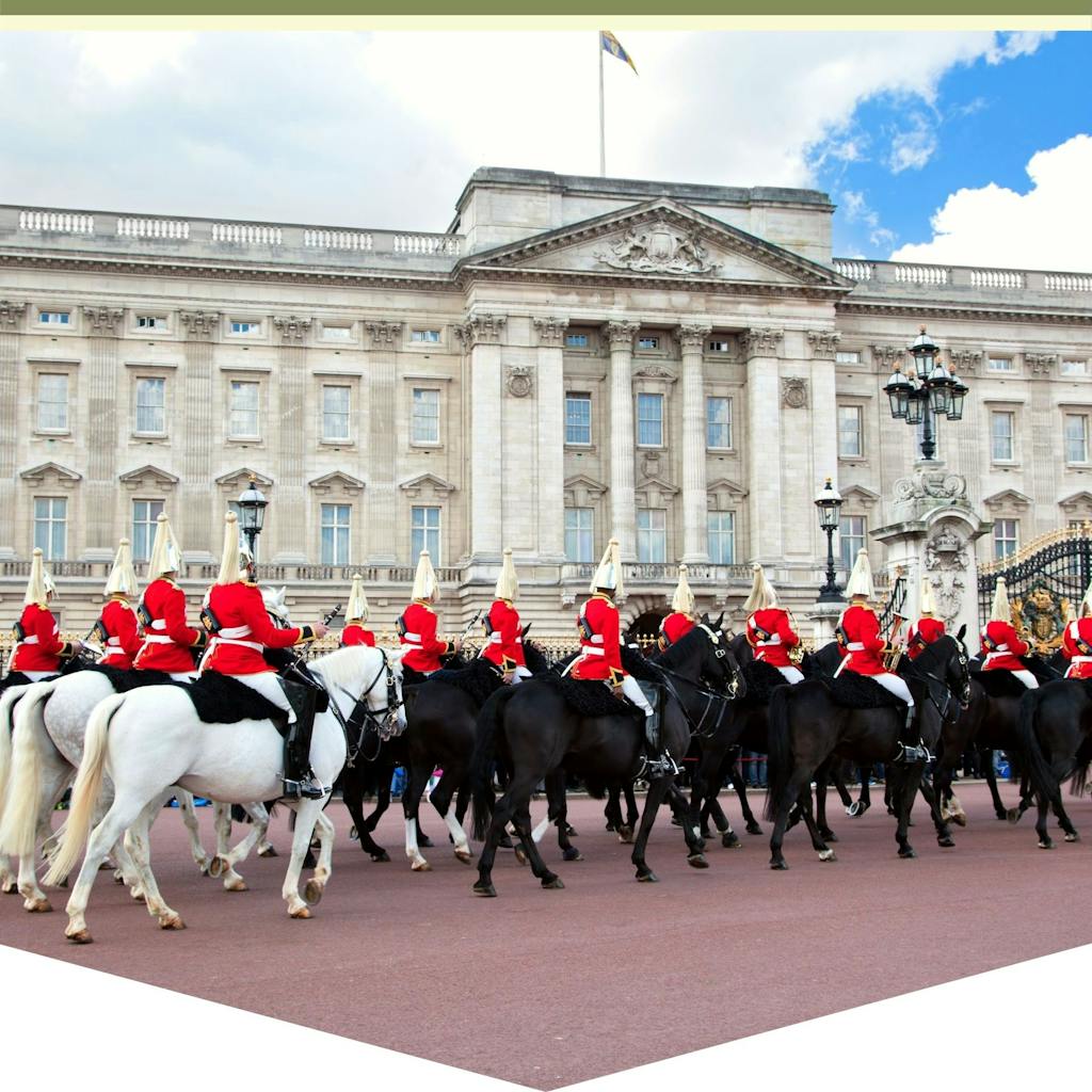 a group of people riding on the back of a horse with Buckingham Palace in the background