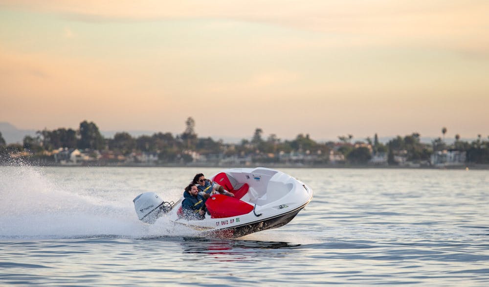 a couple on a date night in San Diego enjoying a Speed Boat Ride