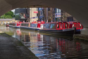 View of boats under canal bridge