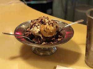 A large bowl of ice cream with two spoons