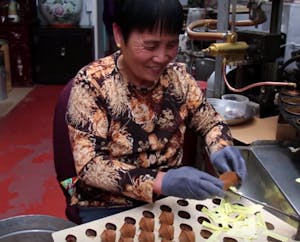 A woman making fortune cookies