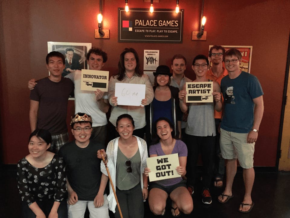 group of people with their completion certificates from the escape room