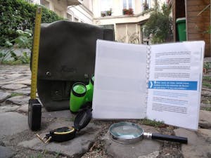 a book, binoculars, magnifying glass, and tape measure