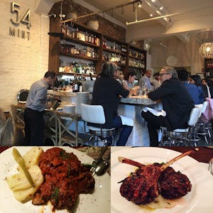 people sitting at the bar at a restaurant with two plates of lamb chops in the foreground