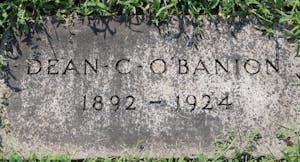 The front of a ground headstone that reads "Dean C. O'Banion. 1892 - 1924"