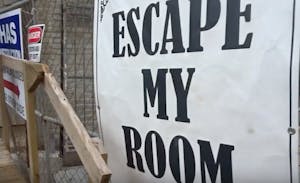 a close up of a sign that says "escape my room"