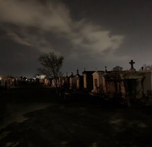 above ground tombs in a cemetery at night