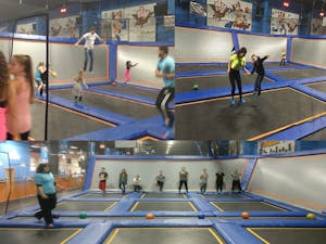 people jumping on trampolines at an indoor trampoline park