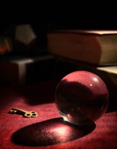 a crystal ball and key on a table