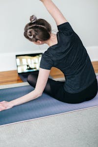 woman doing yoga in front of computer