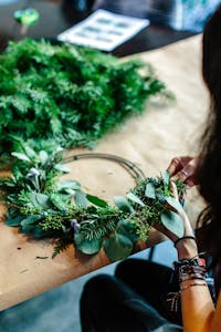 person making a wreath