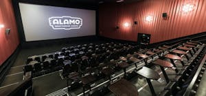 the alamo in nyc theater with red walls and a movie screen