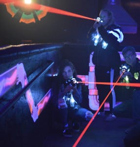 a group of people playing laser tag