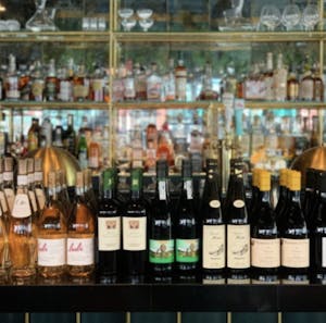 a restaurant bar lined with wine