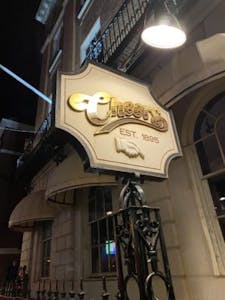 Sign with gold font for Cheers bar in Boston