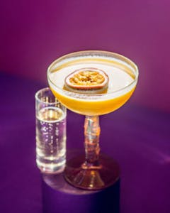a fresh cocktail with a purple background