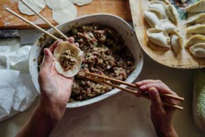 hands making traditional dumplings