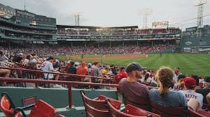 a group of people sitting at a Red Socks game at Fenway