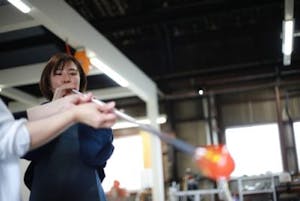 a woman glass blowing