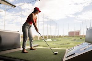 a person with a golf at Top Golf Las Vegas