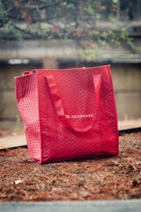 a red door dash delivery bag