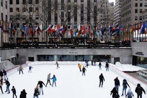 a group of people ice skating at Rockefeller Center