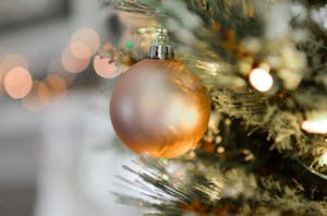 a close up of a gold ornament on a christmas tree