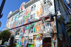  a building with beautiful, colorful murals of women in san francisco