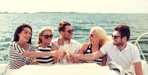 Five friends making a champagne toast on a riverboat tour
